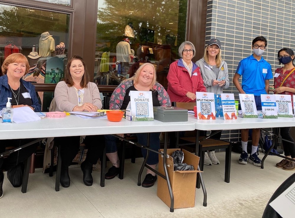 a group of smiling volunteers at a fundraising event
